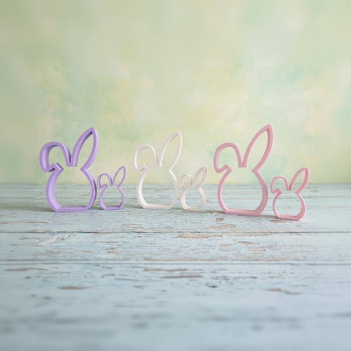 Set of pastel floppy ear Easter bunny shelf sitters in multiple colors on wooden surface