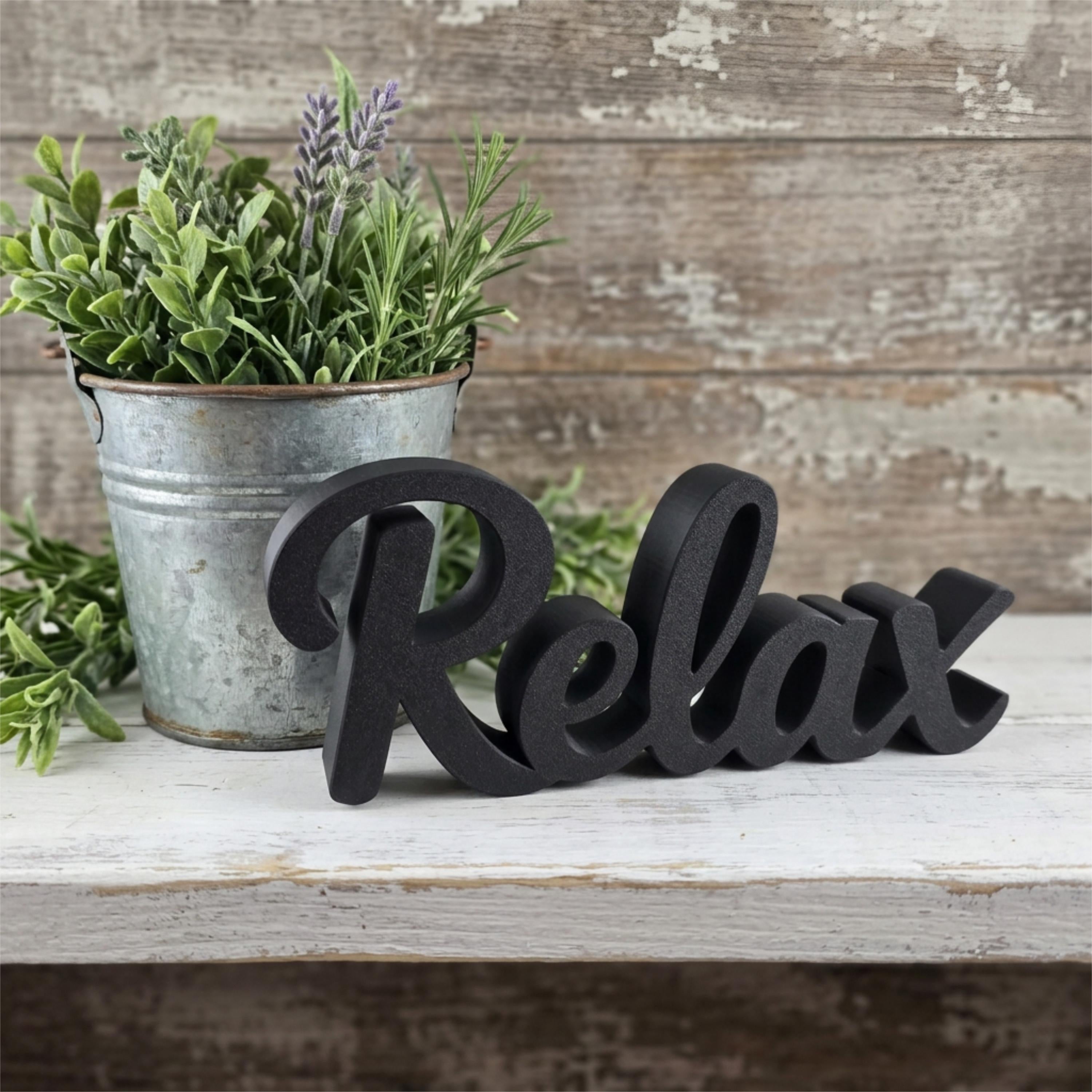 Black Relax sign with potted plant on wooden surface – farmhouse bathroom decor, made in USA