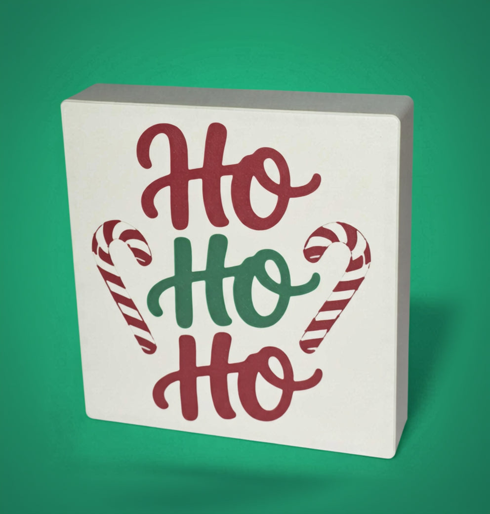Ho Ho Ho Christmas sign with candy cane detail on green background – tiered tray decor, made in USA