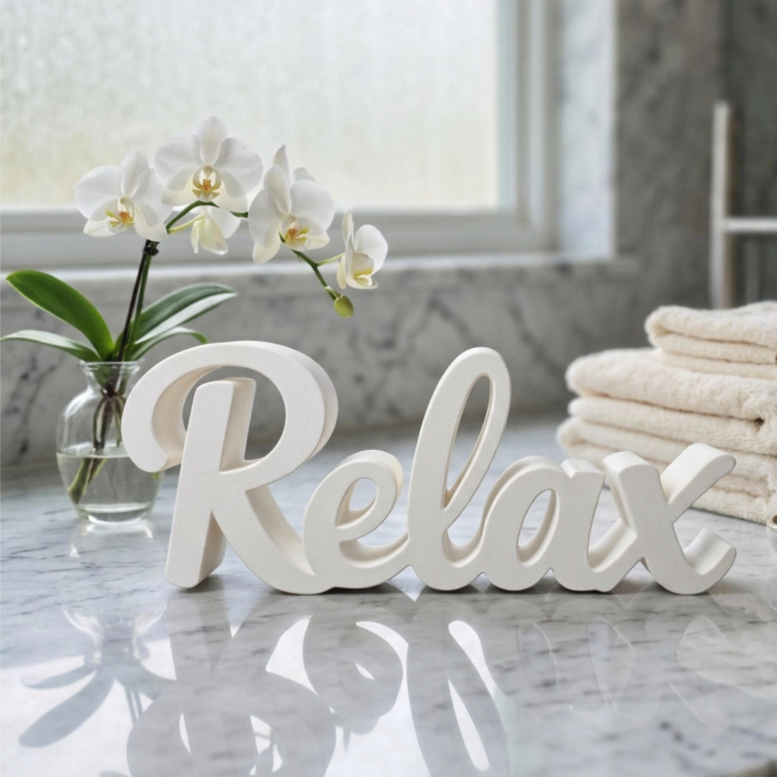 White Relax sign on marble surface with flowers and towels – spa bathroom decor, made in USA