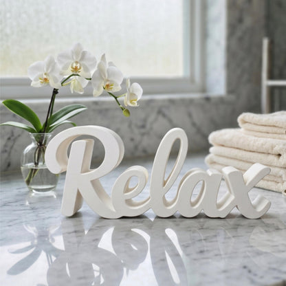White Relax sign on marble surface with flowers and towels – spa bathroom decor, made in USA