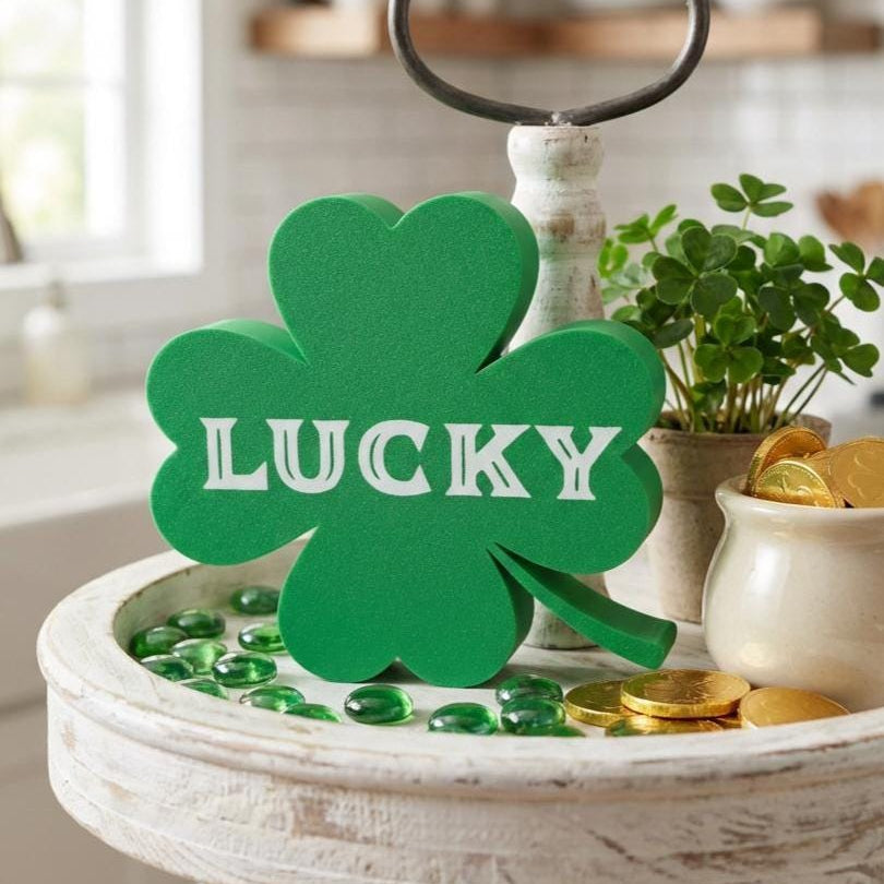 Four leaf clover Lucky sign on decorative stand with gold coins – St. Patrick&