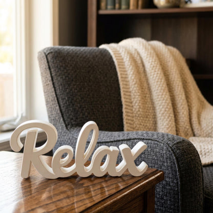 Relax sign on wooden table with cozy armchair in background – home spa decor, made in USA